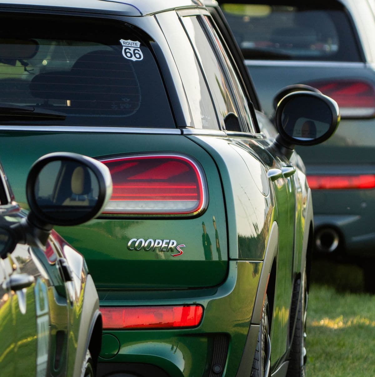 The tail light and badge of a green MINI Cooper S