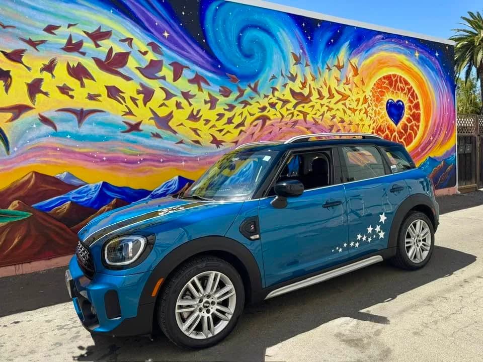 Sora in front of a mural in Northern California