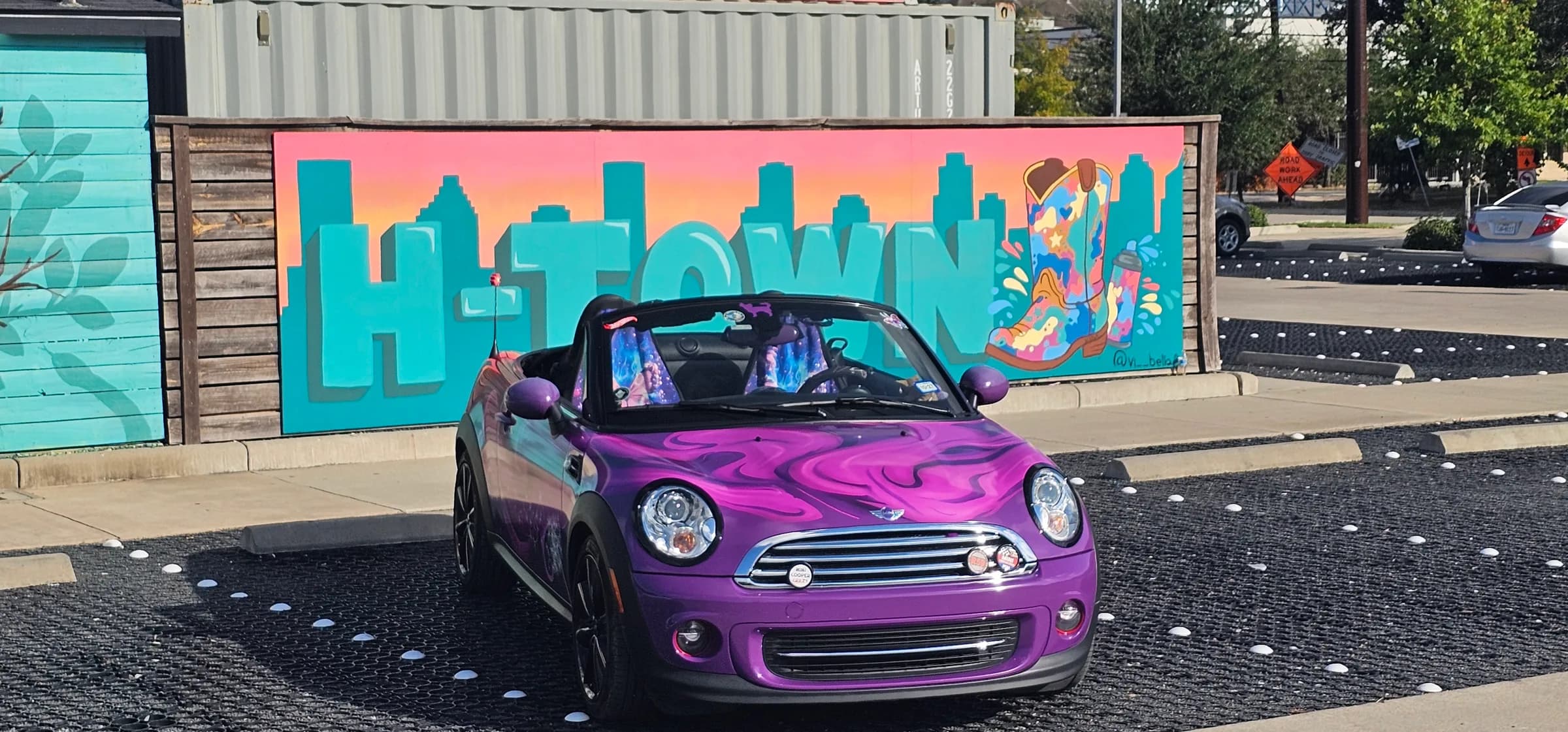 Red car wrapped with purple and pink swirls